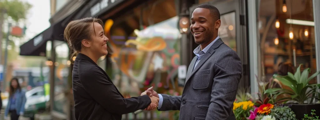 a killeen business owner smiling and shaking hands with a local influencer in front of their storefront.